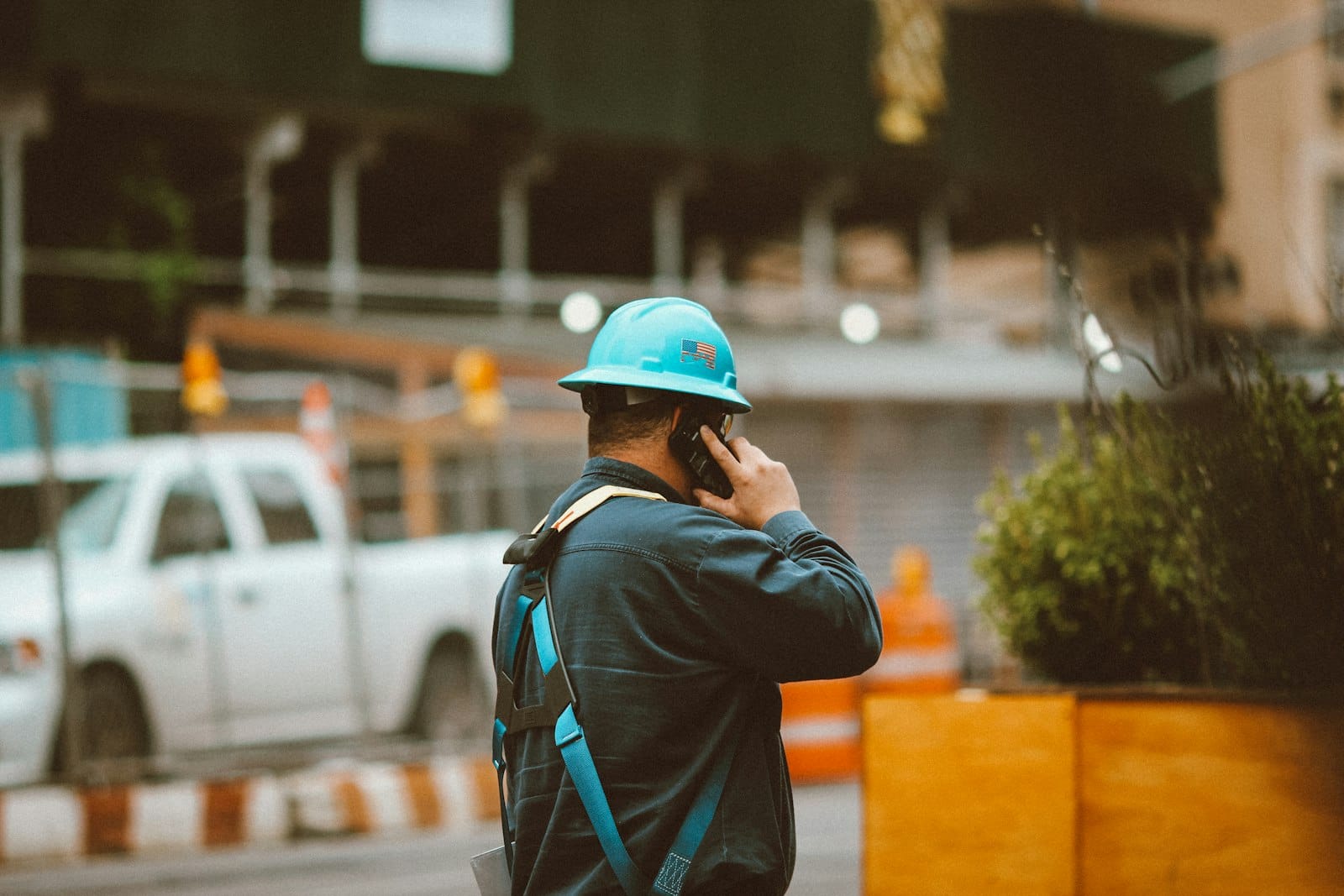 Tradie taking a call next to his ute