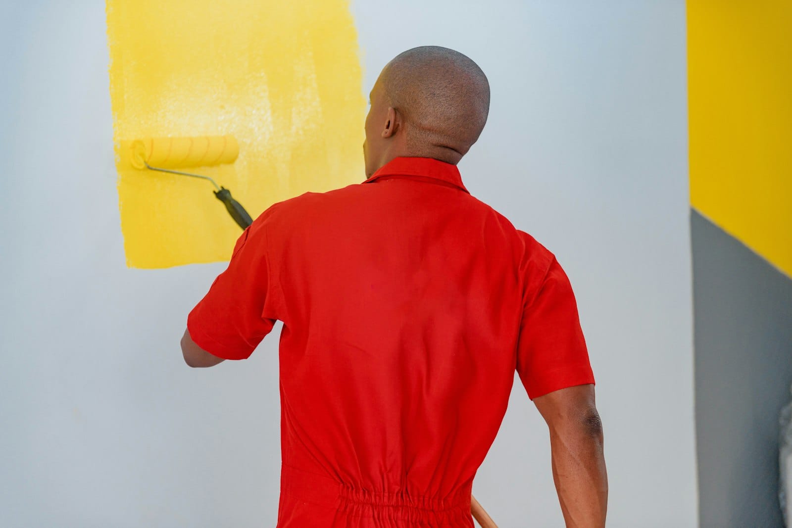 Painter rolling a wall
